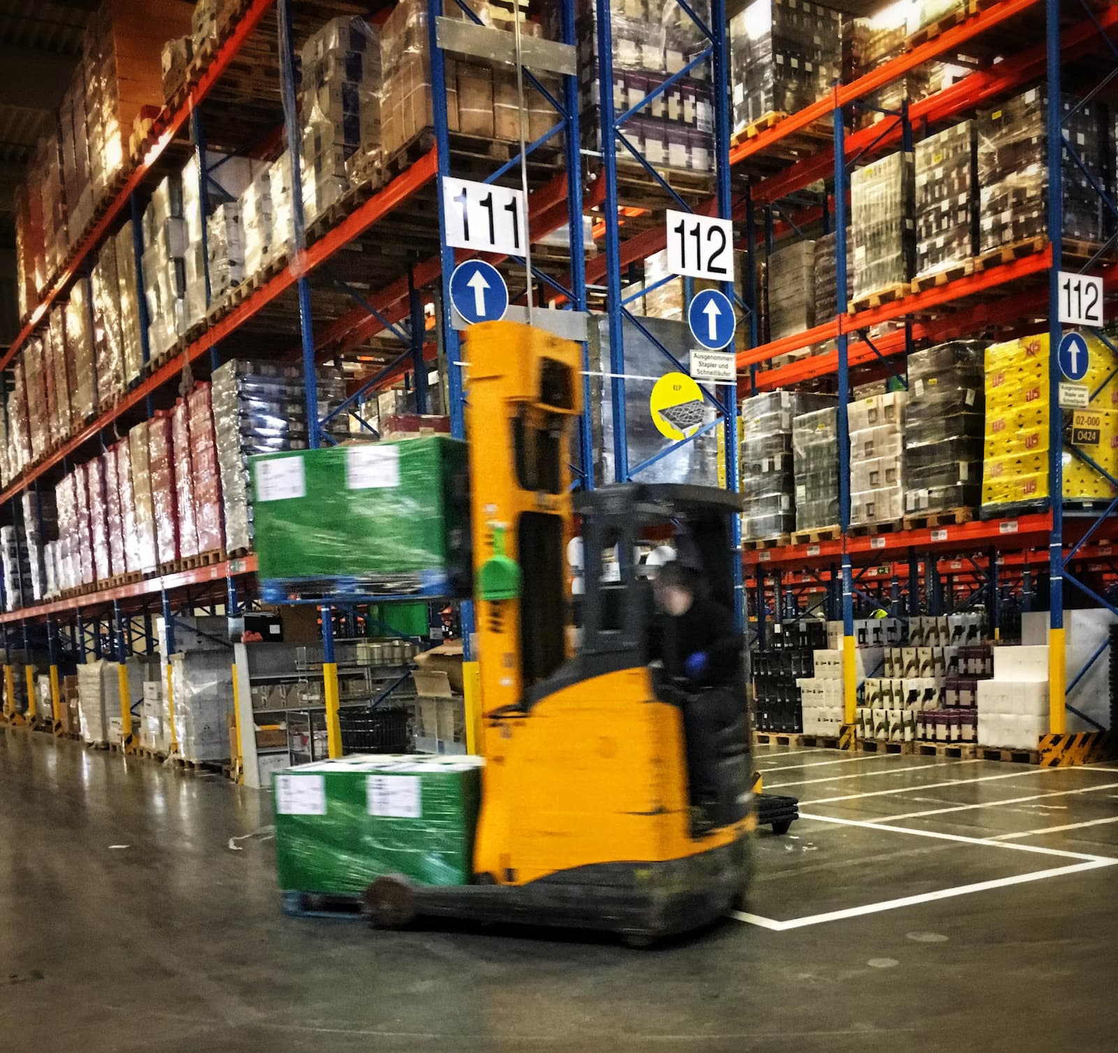 Forklift moving pallets inside a warehouse
